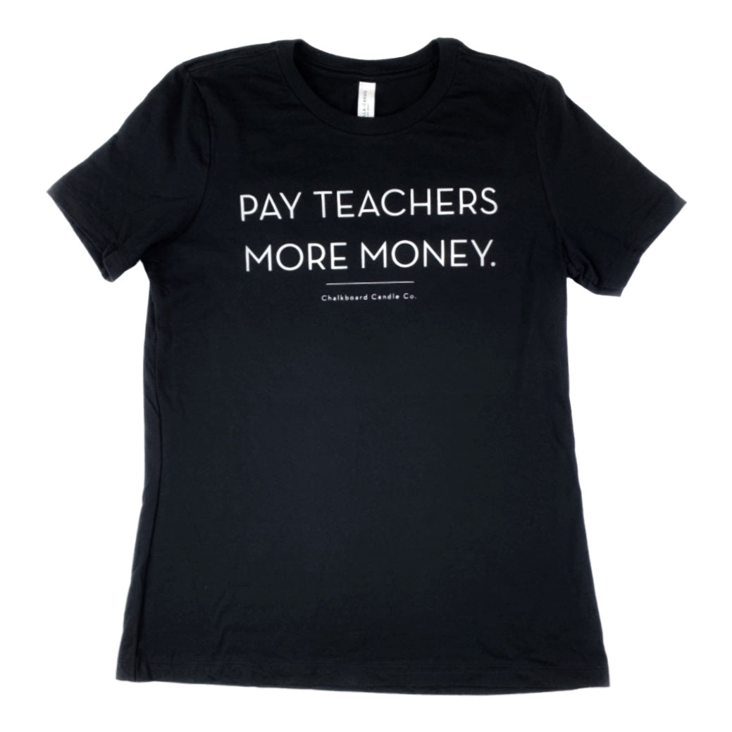 A black women's t-shirt with the text 'PAY TEACHERS MORE MONEY' printed in white on the front with a white background.